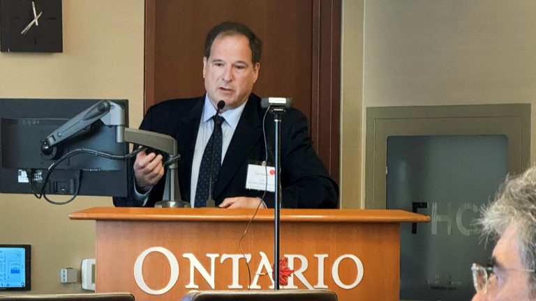 Man speaking at a podium that reads "Ontario"